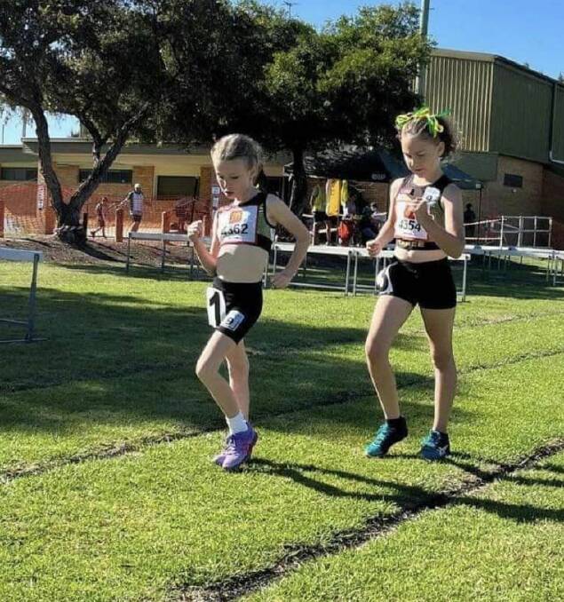 Matilda Beck-White and Isabelle Black competing in the U9 girls race walking. Matilda won and Isabella finished second. Taree contested the walking events for the first time and won all seven races. Picture Taree Little Athletics Club. 