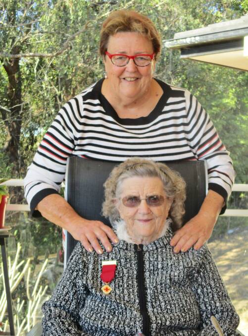 Special occasion: Valda Minns was presented with her 10 year Long Service Medal at the Tinonee & District Red Cross July meeting.
