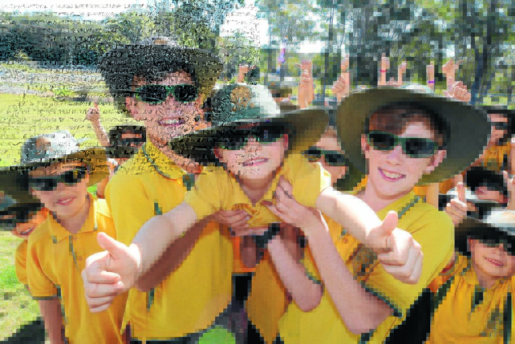 Thumbs up for sun safety: Bevan Smith, Tristan O'Connor and Kye Telfer surrounded by their Mitchells Island Public schoolmates.